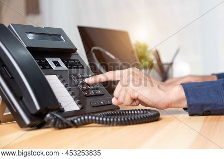 Call Center Staff Man Hand Point To Press The Button Number On The Phone Office Desk , Communication