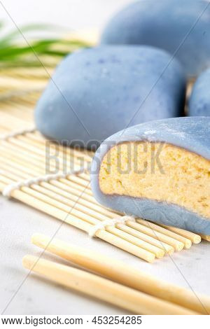 A Japanese Mochi Lying On A Wooden Mat On White Countertop. Concept Of A Traditional Japanese Rice C