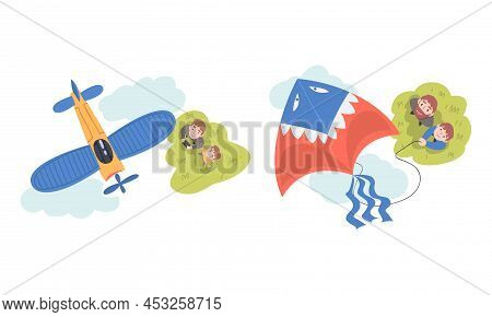 Dad And Son Launching Aircraft Model And Kite Outdoors. View From Above Of Parents And Children Watc