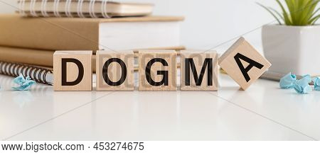 Dogma Text On The Wooden Block With Notebooks ,keyboard With Chart.