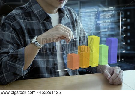Man In Casual Cloth Interacting With Futuristic Augmented Reality Virtual Graph Of Business Informat
