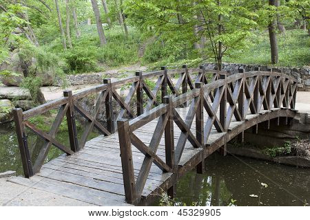 Ponte de madeira sobre um pequeno rio no parque de Sophia em Uman