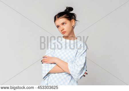 Bored Teen Girl Looking Aside With Sad, Gloomy And Unamused Expression, Standing Upset And Moody In 