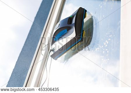Detail Of A Glass Cleaning Robots Acting Behind A Window