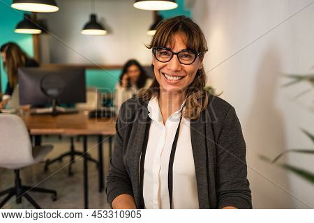 Happy Latin Woman In Coworking Creative Space