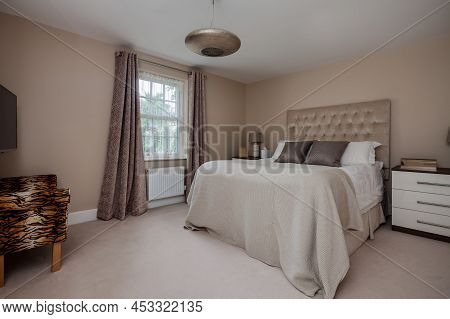 Newmarket, Suffolk, England - June 20 2017: Modern Furnished Bedroom With Bed, Sidetable And Armchai