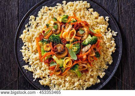 Quinoa Topped With Stir Fried Broccoli, Julienne Carrots, Sun Dried Tomatoes, Leek And Mushrooms On 