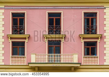 Balcony And Several Windows In A Row On The Facade Of The Modern Urban Apartment Building Front View