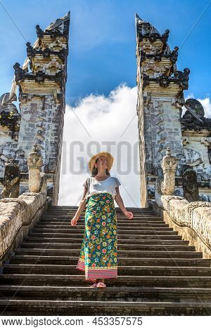 Woman Traveler At Ancient Gate At Pura Penataran Agung Lempuyang Temple On Bali, Indonesia