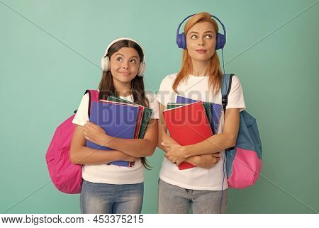 Thoughtful Private Teacher And Kid In Earphones Holding Textbook And School Bag, Estudy
