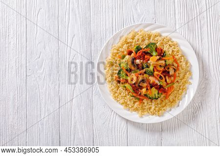 Quinoa Topped With Stir Fried Broccoli, Julienne Carrots, Sun Dried Tomatoes, Leek And Mushrooms On 