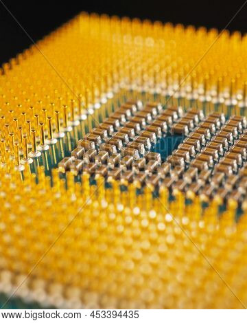 Computer Hardware. Processor Lies On Dark Matte Surface. Closeup. Pins And Connectors. Vertical Stor