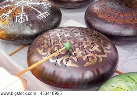 Glucophones Or Tank Drums With Wooden Sticks Are Sold At A Street Stall. Ethnic Musical Instruments