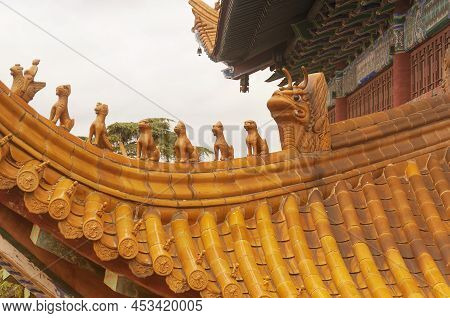 Golden Animal Figurines And Symbols Protecting The Buddhist Jinshan Temple On An Overcast Day In Zhe