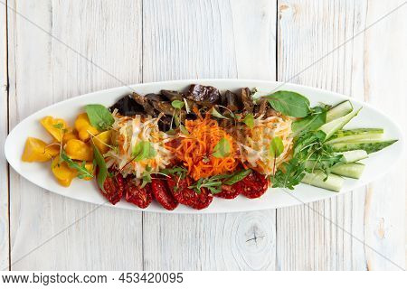 Assorted Vegetables In A Bowl. View From Above. Sun-dried Tomatoes, Pickled Squash, Cabbage, Carrots