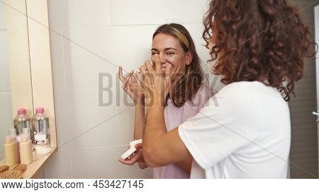 Man Want Smearing Foam On Smiling Girlfriend Nose While Shaving. Girl Holding Cosmetic Cream. Young 