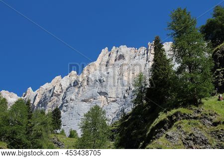 The View Of A Mountain Massif And Green Forest At Foothills In A Sunny Day.