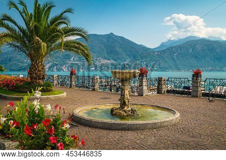 Cute Small Water Fountain And Flower Decoration With Palm Trees On The Promenade. Fantastic Location