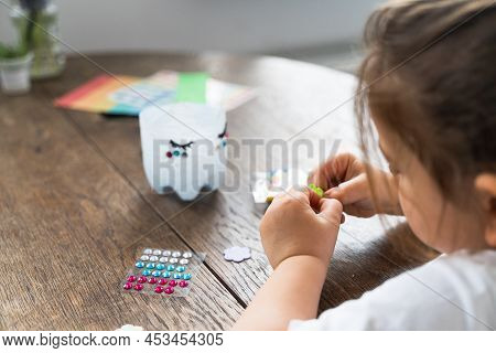 Caucasian Preschool Girl Doing Crafts With Plastic Bottle And Paints. Recycle Upcycling Waste. Susta