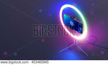 Phone On Rgb Led Ring Light On Tripod On Table. Smartphone Streams Video In Internet. Vlogging Conce