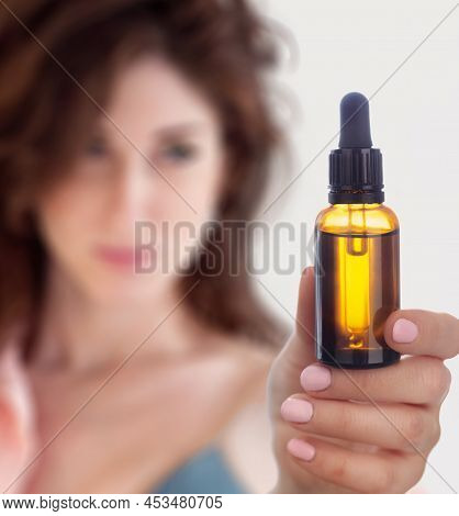 Woman Holding In Her Hands Bottle With Dropper, Essential Oil. Concept Of Healthy Lifestyle, Bach Th