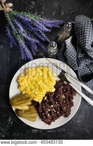 Fried Black Pudding With Mashed Potatoes And Pickled Cucumber.