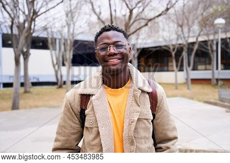 Close Up Shot Of Cheerful Happy African American Teenage Boy Looking At Camera Smiling. Intense Look