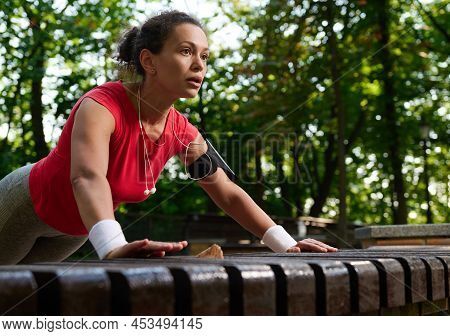 Close-up Of A Determined Hispanic Female Athlete, Muscular Build Woman In Bright Sportswear Performi