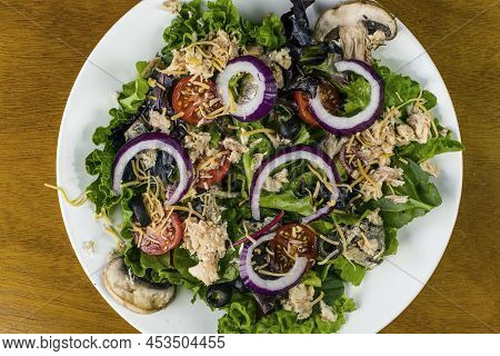Mixed Salad  With Salmon , Red Onions  Shredded Cheese And Black Olives