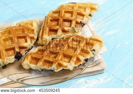 Croffle With Chocolate. A Popular Dish Is A Hybrid Of Croissant And Waffle. Blue Background