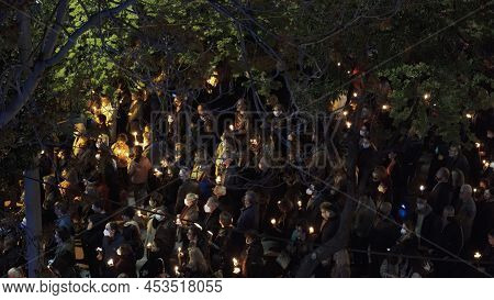 Thessaloniki, Greece - April 22 2022: Gathered Crowd Holding Candles In The Streets At Night. People