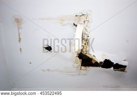 Ceiling Panels Damaged Hole In The Roof Office From Drain Pipes Water Leakage. Office Building Or Ho