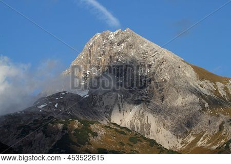Alpine Mountain Landscape With Clouds In Austria