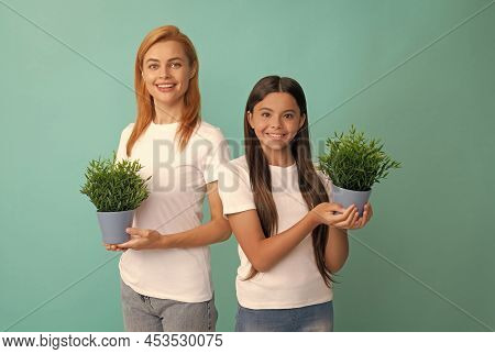Fostering And Adoption. Happy Adopted Child And Mother Hold Houseplants. Foster Family. Fostering