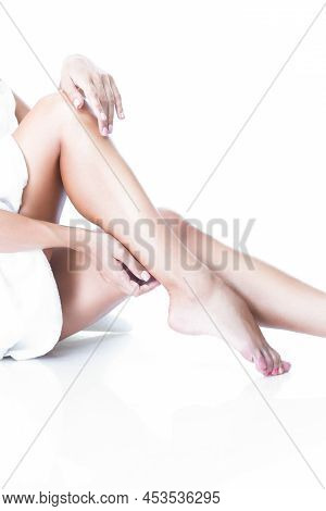 Skincare And Spa Concepts. Perfect Female Body With Straight Tanned Legs Wrapped With White Bath Tow