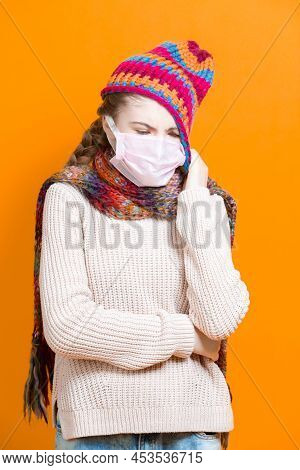 Healthcare Ideas.teenage Female Girl In Warm Knitted Hat And Scarf Using Facial Mask Against Viruses