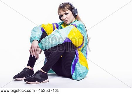 Sitting Winsome Caucasian Female Athlete Sportwoman In Fitness Sexy Outfit Wearing Wireless Headphon