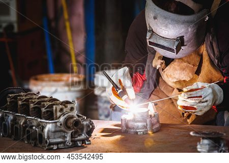 The Man In The Face Mask Is Welded By Argon Welding. Welder Industrial Worker Welding With Argon Mac