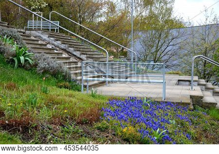 Between The Stairs Is A Waterfall With Stones And Boulders. Artificial Stream With A Waterfall Betwe