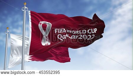 Doha, Qatar, January 2022: Flags Qatar 2022 World Cup Logo Waving Among Qatar National Flag In The W