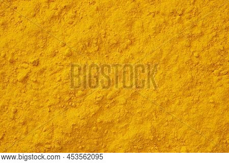Turmeric Spice Background. Curcuma Powder Seasoning Texture.