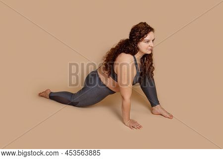 Lumpish Begginer Fat Obese Red Hair Woman Doing Sports Stretch, Sitting Half Splits. Spine And Muscl