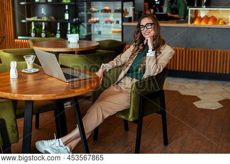 Business Woman Restaurant Owner Use Laptop Dressed Elegant Pantsuit Sitting Table In Restaurant With