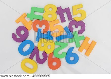 Zero To Nine Plastic Number Set On A White Background In Random Order