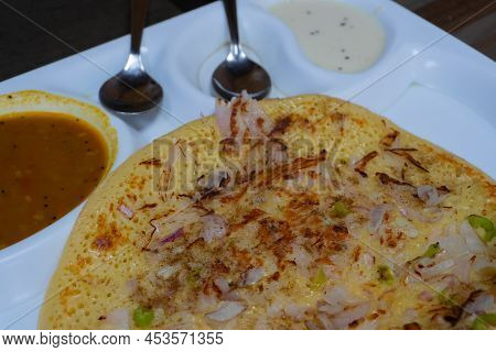 Uttapam Is Served With Chutney On White Plate, Indian Vegetable Dish.