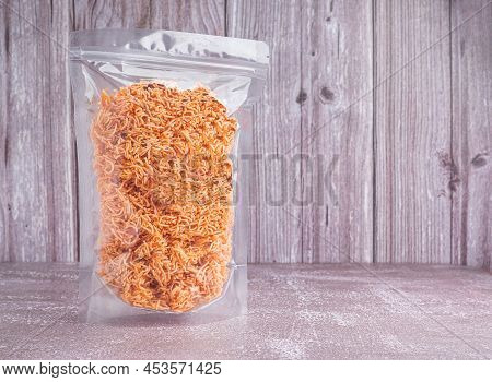 Side View Of Sweet And Sour Crispy Noodles Or Mee Krob In The Thai Language In A Clear Package Place