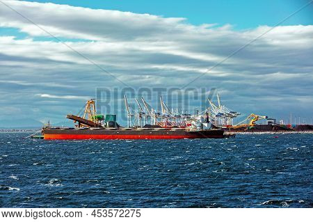 Ships Under Loading In The Seaport In The City Of Tsawwassen, Stormy Sea Dramatic Sky, Overcast