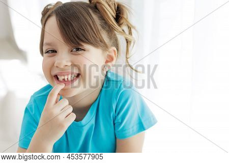 The Kid Lost A Tooth. Baby Without A Tooth. Portrait Of A Little Girl No Tooth. High Quality Photo