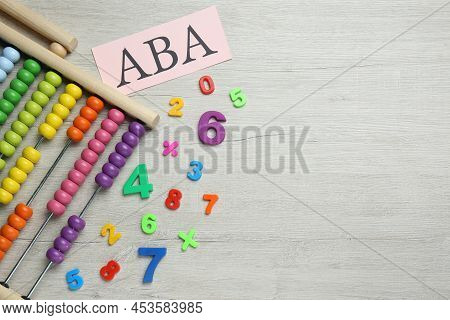 Paper Sheet With Abbreviation Aba (applied Behavior Analysis), Abacus And Colorful Numbers On White 