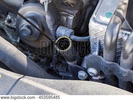 Oil Dipstick In A Diesel Engine. Engine Breakdown From Low Oil Level, Industry